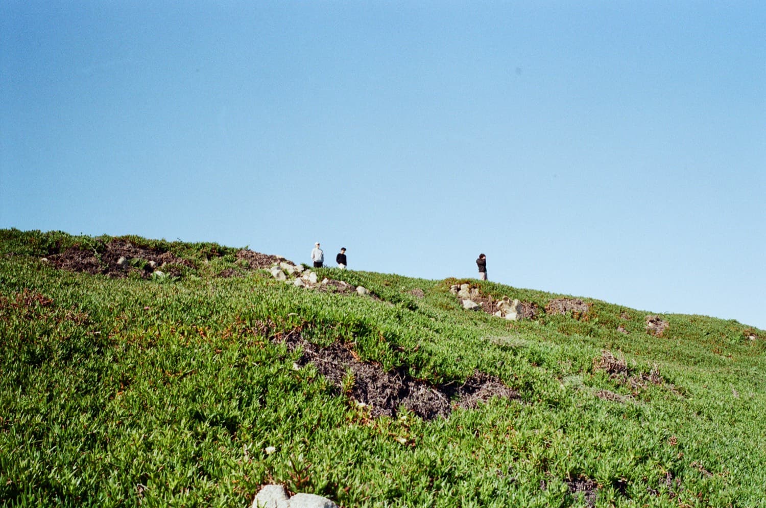 A runner moving through a wide mountain landscape